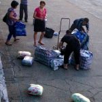 Contraband is thrown off the train, collected and carted off.