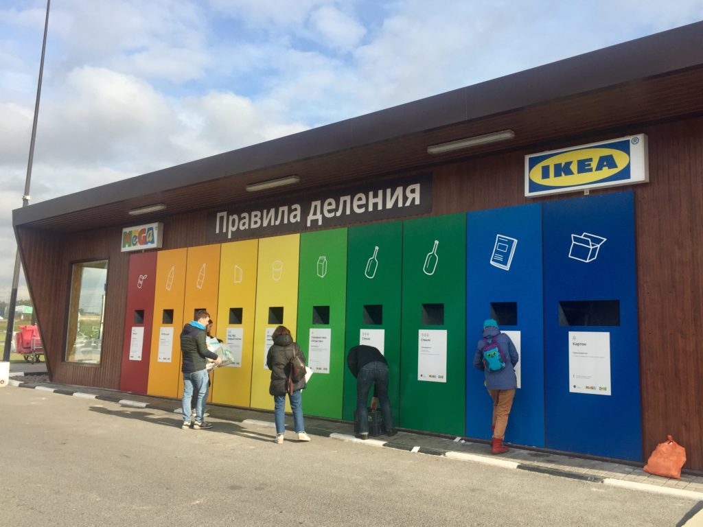 A group of people standing in front of a building
Description automatically generated